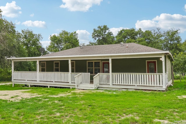 back of property with a porch and a yard