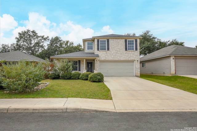 view of front of home with a front yard and a garage