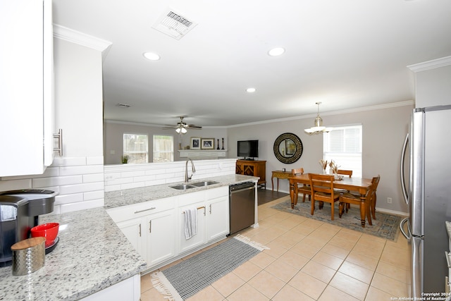 kitchen featuring white cabinetry, sink, ceiling fan, stainless steel appliances, and backsplash