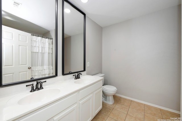 bathroom featuring tile patterned flooring, vanity, and toilet