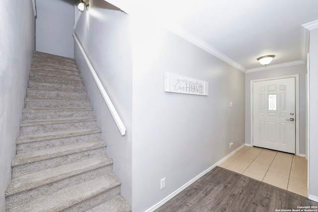 foyer entrance with hardwood / wood-style floors and ornamental molding