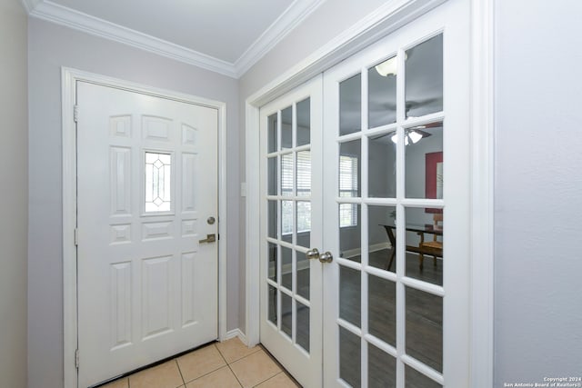 doorway to outside with crown molding, french doors, light tile patterned flooring, and a healthy amount of sunlight