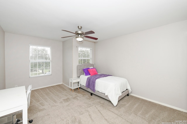 bedroom featuring ceiling fan and light carpet