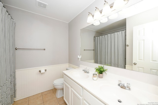 bathroom featuring toilet, vanity, and tile patterned floors