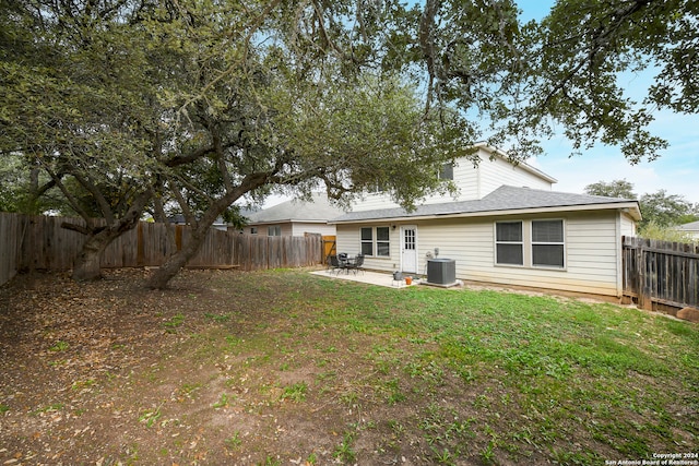 back of house featuring a yard, a patio, and central air condition unit