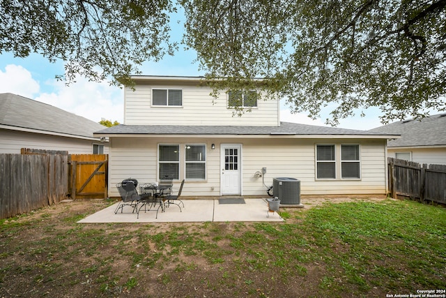 rear view of property featuring a yard, a patio area, and central air condition unit