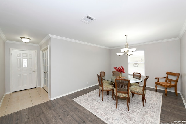 dining space featuring a notable chandelier, wood-type flooring, and ornamental molding