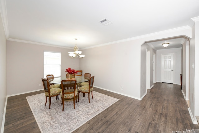 dining space featuring dark hardwood / wood-style flooring, a chandelier, and ornamental molding