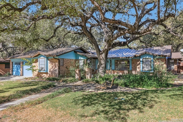 ranch-style house with a garage and a front lawn