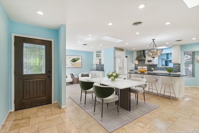 dining area with a skylight and sink