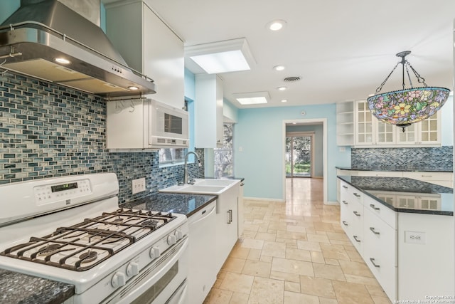 kitchen with white appliances, white cabinets, sink, wall chimney exhaust hood, and decorative backsplash