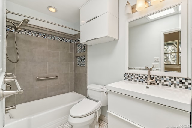 full bathroom with tile patterned flooring, backsplash, toilet, vanity, and tiled shower / bath