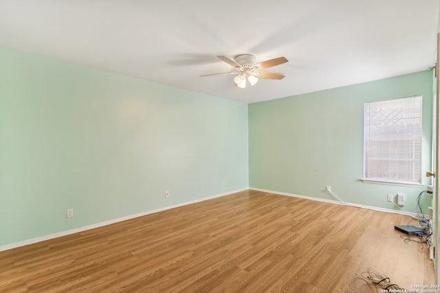 unfurnished room with light hardwood / wood-style flooring and ceiling fan