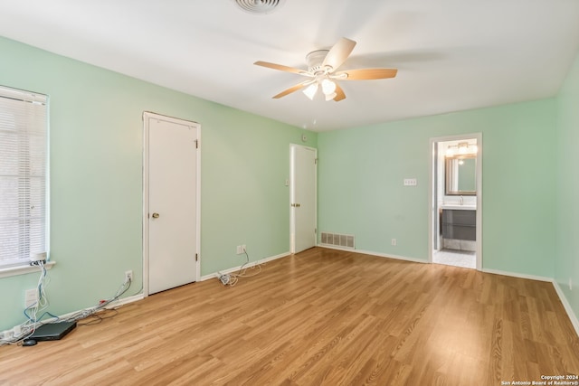 unfurnished bedroom with ceiling fan, light hardwood / wood-style flooring, and ensuite bathroom