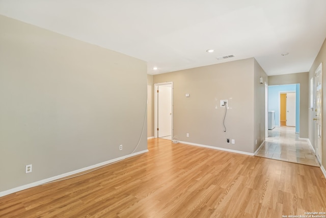 empty room with light hardwood / wood-style flooring