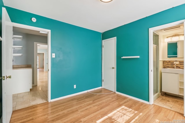 unfurnished bedroom featuring light wood-type flooring