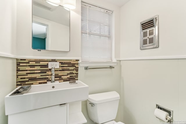 bathroom with backsplash and toilet