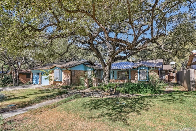 single story home featuring a front yard and a garage