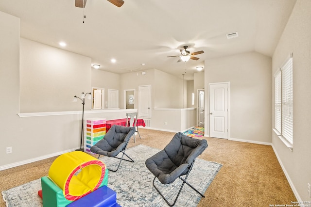 rec room featuring carpet, vaulted ceiling, ceiling fan, and a healthy amount of sunlight