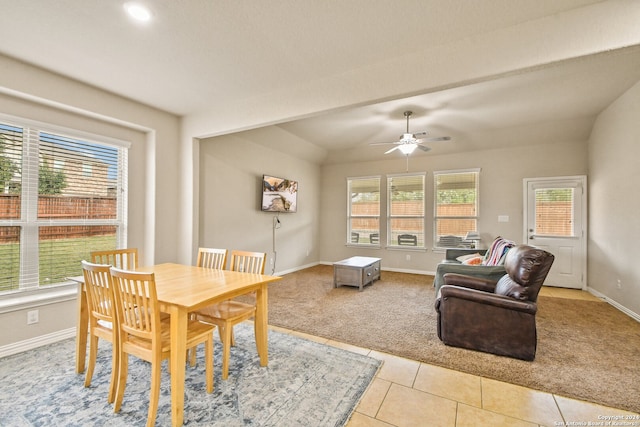 tiled dining room featuring vaulted ceiling and ceiling fan