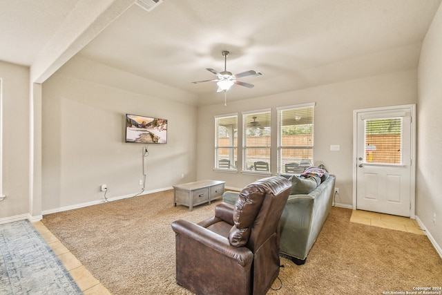 living room with a wealth of natural light, light tile patterned floors, and ceiling fan