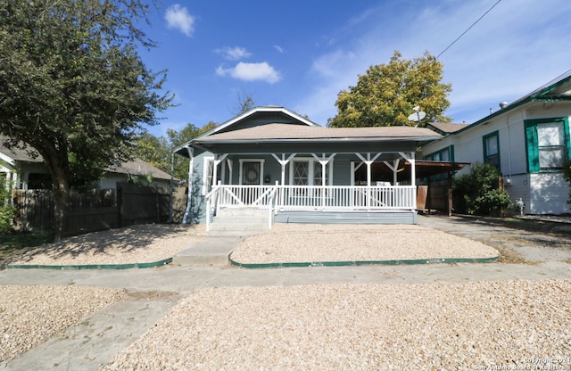 back of house featuring a porch