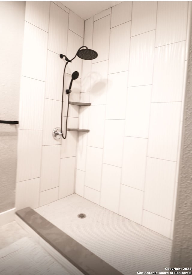 bathroom with a tile shower