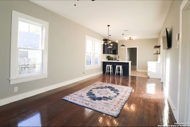 interior space featuring dark hardwood / wood-style floors, sink, and an inviting chandelier