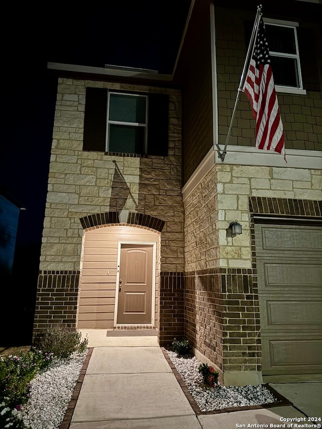 view of exterior entry with a garage