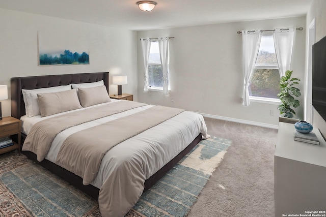 bedroom featuring multiple windows and dark colored carpet