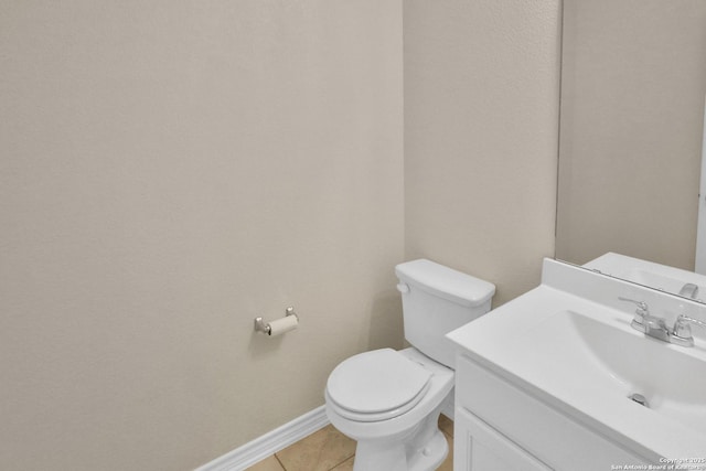 bathroom with vanity, tile patterned floors, and toilet