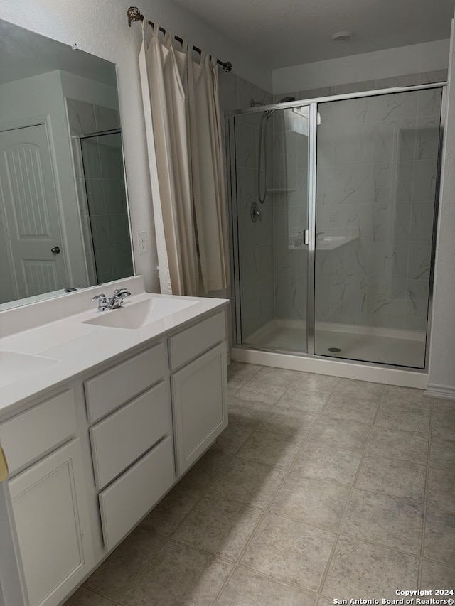 bathroom with vanity and an enclosed shower