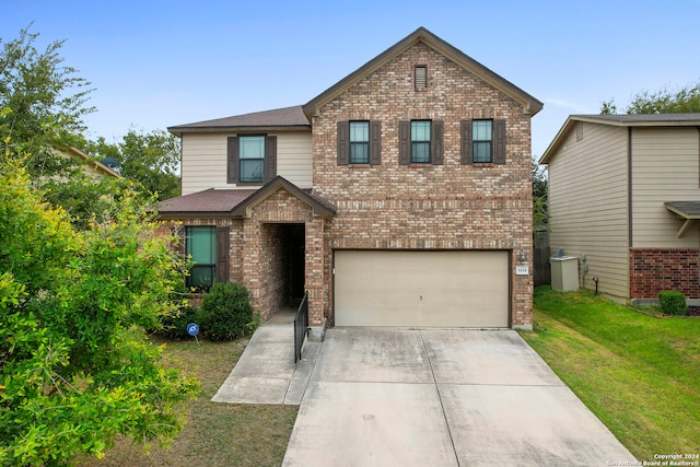 view of front facade with a front yard and a garage