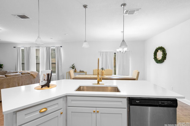 kitchen with sink, stainless steel dishwasher, a notable chandelier, a kitchen island with sink, and light tile patterned flooring