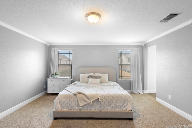 carpeted bedroom featuring a textured ceiling and crown molding