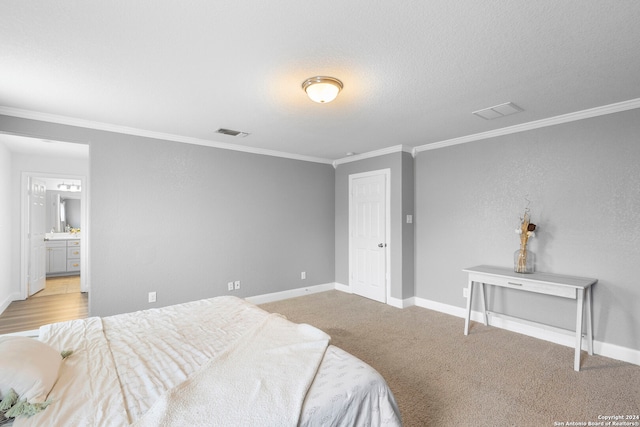 carpeted bedroom with a textured ceiling and crown molding