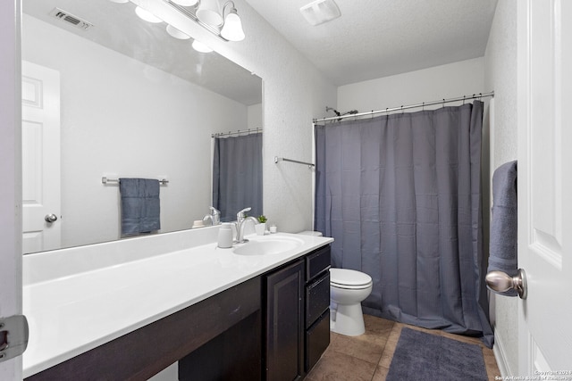 bathroom featuring a shower with curtain, tile patterned floors, a textured ceiling, toilet, and vanity