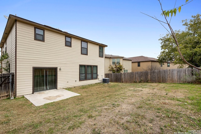 rear view of house with a lawn, a patio, and central AC unit