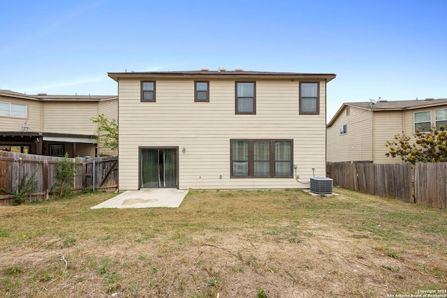 rear view of property featuring central AC, a yard, and a patio