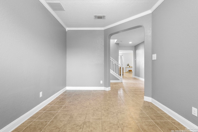 unfurnished room featuring light tile patterned flooring and ornamental molding