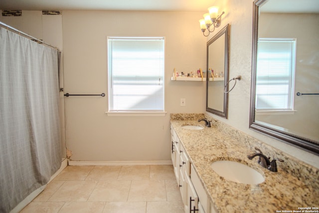 bathroom featuring tile patterned flooring, vanity, and curtained shower