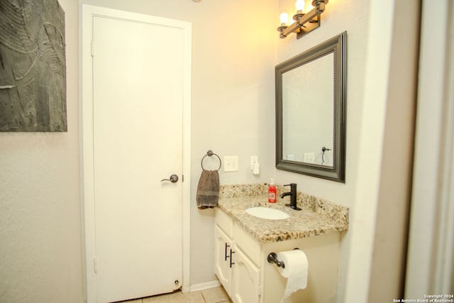 bathroom featuring tile patterned flooring and vanity