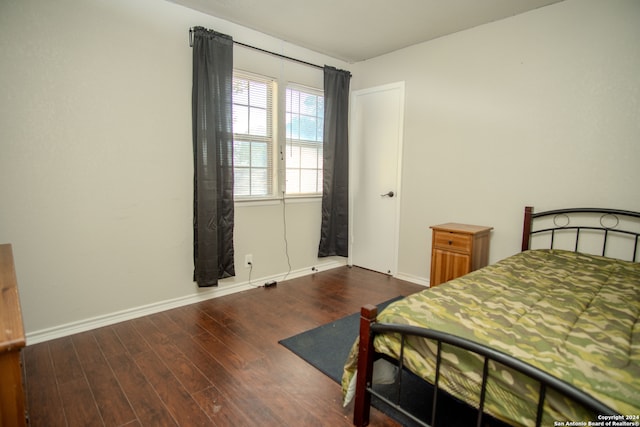 bedroom featuring dark hardwood / wood-style flooring