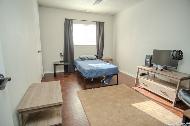 bedroom with ceiling fan and dark hardwood / wood-style floors