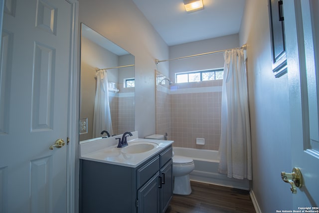 full bathroom with shower / bath combination with curtain, toilet, wood-type flooring, and vanity