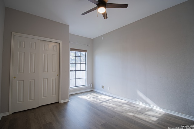 unfurnished bedroom with hardwood / wood-style flooring, ceiling fan, and a closet