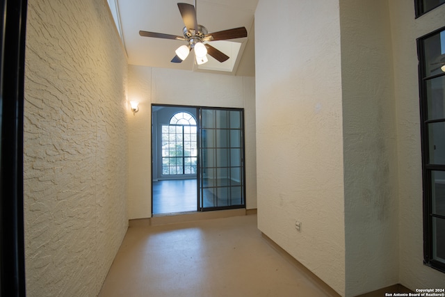 interior space with ceiling fan and lofted ceiling