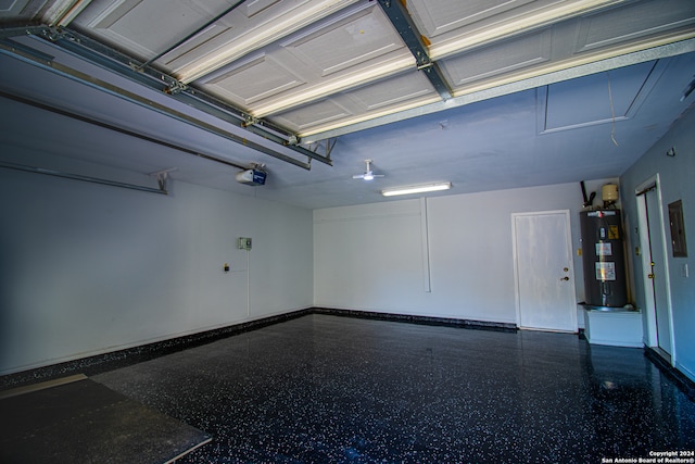 garage with water heater and a garage door opener