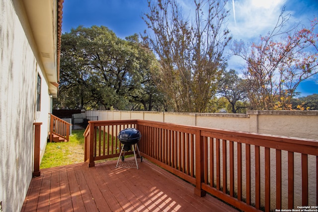 wooden terrace featuring grilling area