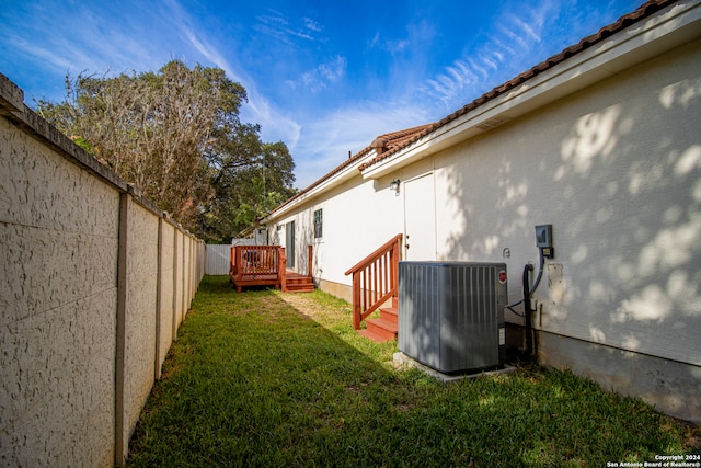 view of yard featuring a wooden deck and cooling unit